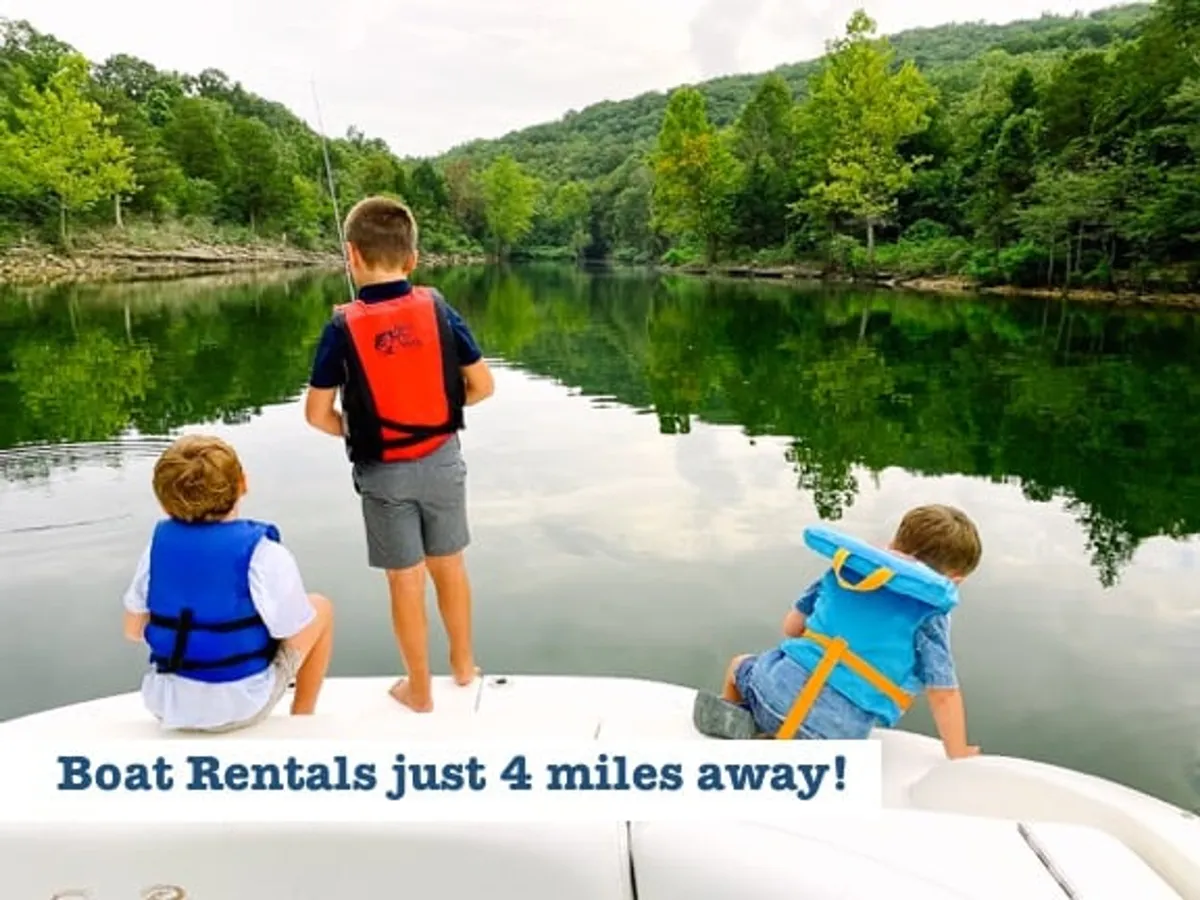 This image features children in life jackets enjoying calm water surrounded by green landscape, evoking playful exploration and water-based activities typical of Table Rock Lake or Long Creek Marina.